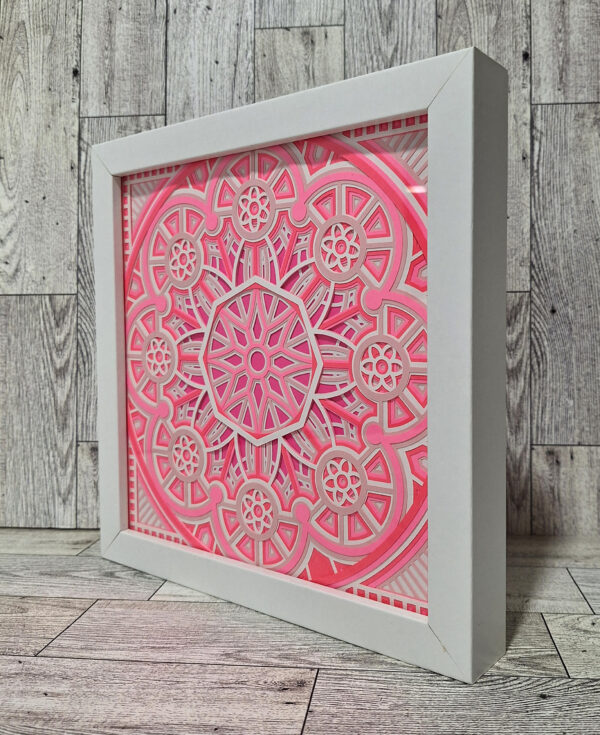 Angled view of pink papercraft shadow box.