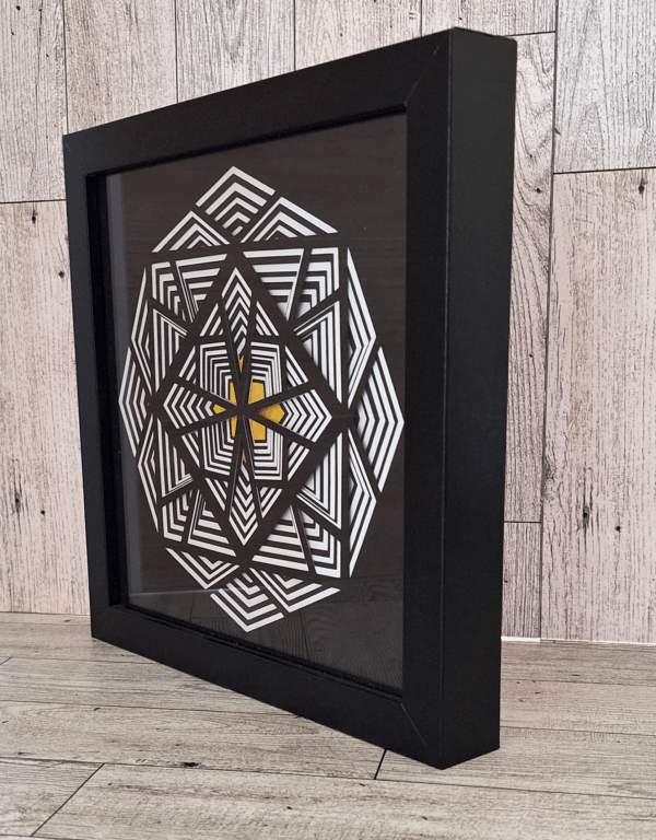 Side view of black and white paper art with gold center