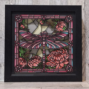 Dragonfly made of layered paper in a black shadowbox frame