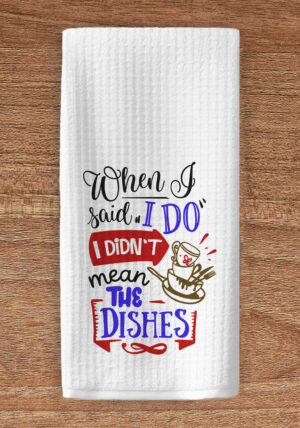 Kitchen towel imprinted with a graphic of dishes and the title text