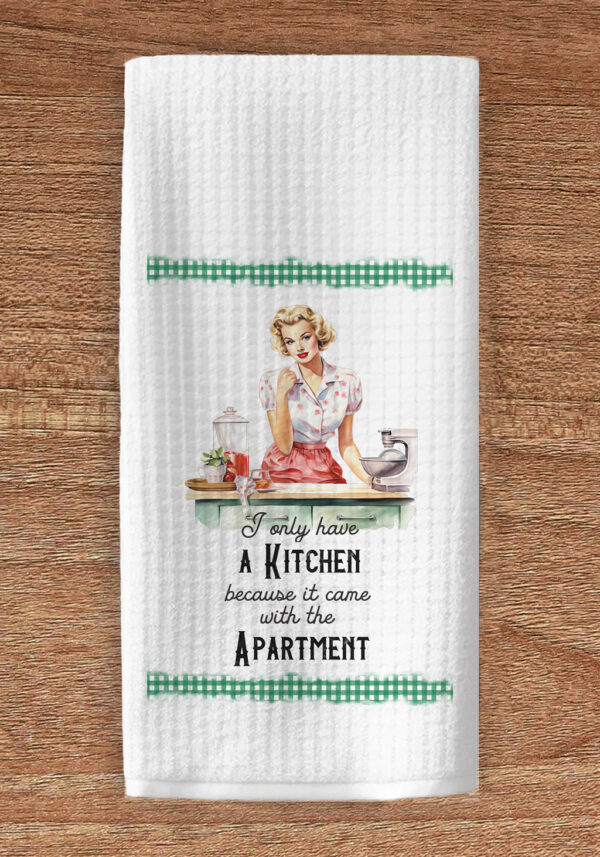 Kitchen towel imprinted with vintage housewife image and title text