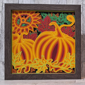 Layered paper art shadow box of pumpkins and fall leaves.