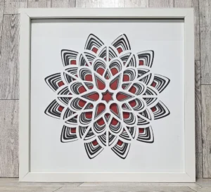 Layered paper red, white, and black flower shape.