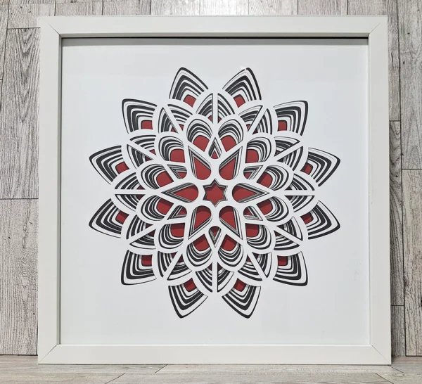 Layered paper red, white, and black flower shape.